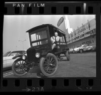 Eugene Walsh, Ralphs Grocery Co. president, riding in a Ralphs 1917 Model T Ford delivery truck in Los Angeles, Calif., 1973