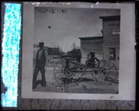 John Leckie standing next to his homemade horseless carriage, Santa Ana, 1898