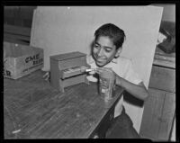 Student paints a toy piano for charity, Los Angeles, 1938