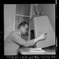 San Fernando Valley State College's Dr. Vern L. Bullough studying microfilm of rare science books, 1965