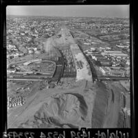 Aerial view of excavation and beginning construction of Santa Monica Freeway at La Cienega and Venice Blvds, 1964