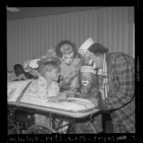 Ringling Bros. and Barnum & Bailey Circus clowns Coco and Bobby Kaye visiting a patient at Los Angeles Orthopaedic Hospital, 1970