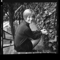 Actress Sandy Duncan seated on ivy covered steps, 1971