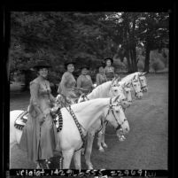 Five women riding Camarillo white horses during Old Spanish Days Fiesta in Santa Barbara, Calif., 1965