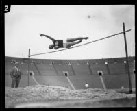 U.S.C. high jumper leaps over the bar during the U.S.C. and Occidental dual track meet, Los Angeles, [1926]