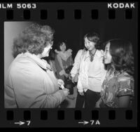 Red Cross caseworker Connie Frentzos greeting Cambodian refugees upon their arrival in Los Angeles, Calif., 1980