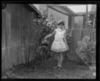 Dolly Wright pouring from a watering can, Los Angeles, 1926