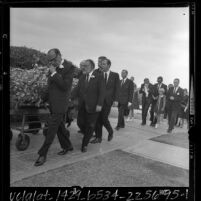 Pallbears accompanying casket of Gracie Allen as her husband, George Burns and family follow, Calif., 1964