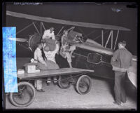 C. N. "Jimmie" James climbing into plane for first transcontinental night mail flight service in Los Angeles, 1929