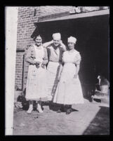 Clara Phillips standing with unidentified man and woman, California, 1915-1922 (?)