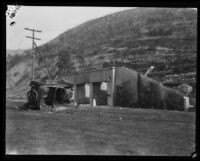 A turned-over car and destroyed house of the Sunset Canyon fires, Los Angeles, 1927