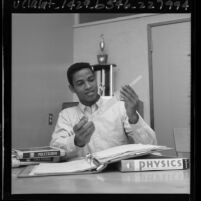 Long Beach Polytechnic High School athlete Gene Washington studying, 1965