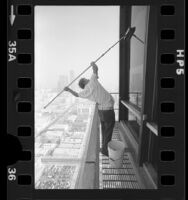 Window washer Vince Schaefer working on skyscraper in Los Angeles, Calif., 1977