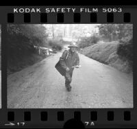 Mailman Jim Korkus walking up steepest street, Fargo Street, in Los Angeles, 1978