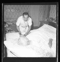 Nurse Tony Assinesi treating a patient, Los Angeles, 1965