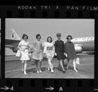 Five flight attendants modeling mod inspired and culturally influenced uniforms, Calif., 1967