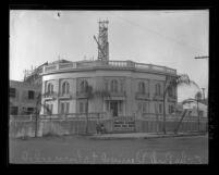 Construction of Angelus Temple with sign reading "Angelus Evangelistic Training School…" in Echo Park, Calif., 1922