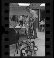 Dr. Thomas Mutch and other scientists examining images of Mars surface, Jet Propulsion Laboratory, Calif., 1976