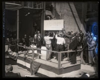 Los Angeles City Hall's cornerstone being lowered down to its place during ceremonies, Los Angeles, 1927