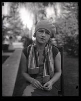 Millicent Sunday seated in a chair in a park or yard, Los Angeles, 1928