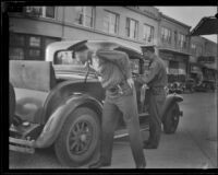 Police officers searching a car, looking for kidnapped girl June Robles, southern Arizona, 1934