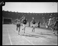 Phil Barber, Charles Borah, an unidentified athlete and Russell Sweet race at an Olympic Club track team event at the Coliseum, Los Angeles, 1928