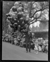 Balloon vendor holding on the route of the Tournament of Roses Parade, Pasadena, 1928