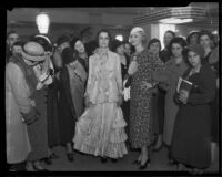 Women surround two fashion models at the 50th anniversary of the Robinson Department store, Los Angeles, 1933