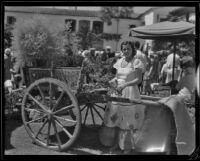 Woman at a display cart at the Old Spanish Days Fiesta, Santa Barbara, 1932