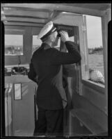 Captain Edward Hyde peers through his binoculars, Newport Beach, 1935