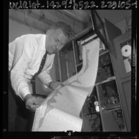 James Ledbetter examining results of air monitoring station in Burbank, Calif., 1964