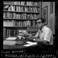 Cal State Los Angeles Poet-in-Residence Henri Coulette seated in his study, 1965