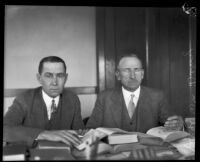 District Attorney Jess Hession and Judge William M. Dehy consulting books, Inyo County, 1927