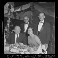 Secretary of State Dean Rusk, Councilwoman Rosalind Wyman sitting at a reception with Justice Stanley Mosk, and Atty. Gen. Thomas Lynch, 1964