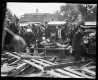 Woman injured by the collapse of a Rose Parade grandstand transported on a litter, Pasadena, 1926