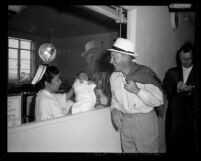 Bing Crosby looking at his newborn son in the nursery of a Los Angeles hospital, 1958