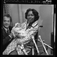 Congresswoman Yvonne Brathwaite Burke and husband William presenting newborn daughter Autumn to reporters in Los Angeles, Calif., 1973