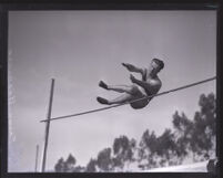 Frank Bradshaw, Occidental College athlete, completing the high jump, Los Angeles