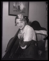 Cellist Mademoiselle Lucienne Radisse poses with her cello, Los Angeles, 1932