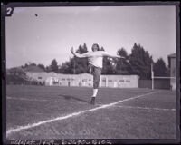 Hurdler Otto Anderson stretches with a leg swing, Los Angeles, 1922-1926