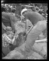 Juan de Lopez is lifted from 1949 pipeline excavation cave-in Pasadena, Calif