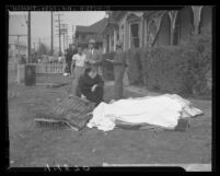 Father Bernardine administering last rites to victim of O'Connor Electro-Plating explosion in Los Angeles, Calif., 1947