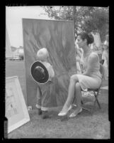 Mike Molletta looks at painting by Bettina Brendel that took third place in show at the Downey Museum of Art, 1959