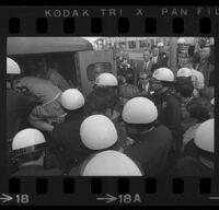 Protesters pushed into police patrol wagon after being arrested for demonstrating at Century Plaza during President Johnson's visit. A. 1967