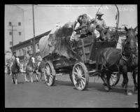 William Parmalee rides in a covered wagon at the La Fiesta de Los Angeles parade, Los Angeles, 1931