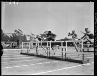 Rafer Johnson competes in the hurdles