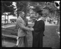 University of Southern California junior and senior class presidents sharing peace pipe and handshake at Ivy Day, Los Angeles, 1926