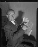 Major O. J. Todd points at a location on the map he holds, Los Angeles, 1935