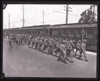 California National Guard 160th Infantry marching besides train, Los Angeles, 1924