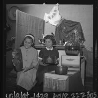 Two female students with Mexican crafts and art at San Jose Street School in San Fernando, Calif., 1963